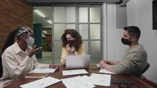 Team Meeting in Office Wearing Masks