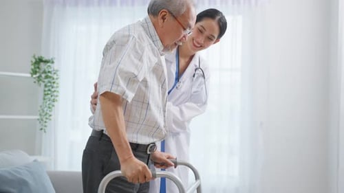 Doctor Helping Senior Patient Walk with Walker