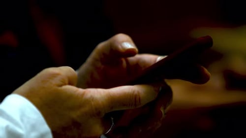 Closeup of person's hands using a smartphone