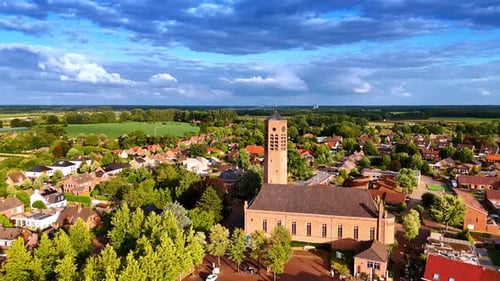 Flying closer to the Saint Lawrence Church with a freestanding clock tower.
