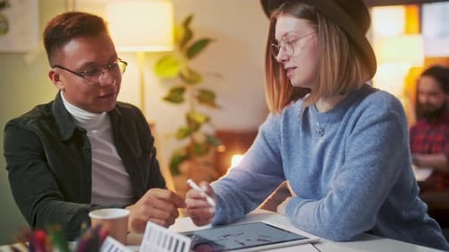 Creative Colleagues Working Together on Tablet Project in Office