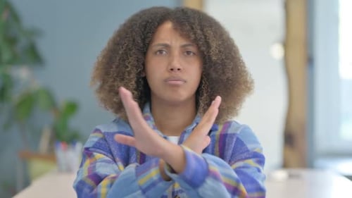 Young Woman Gesturing No with Crossed Arms