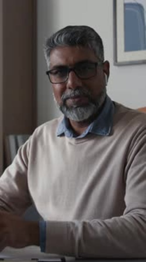 Man with Gray Hair Indoors Wearing Glasses