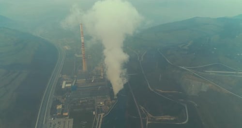 Abstract Aerial View of Coal Power Plant High Pipes with Black Smoke Moving Up Polluting Atmosphere