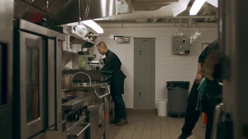 Professional chefs working together in a busy industrial kitchen setting