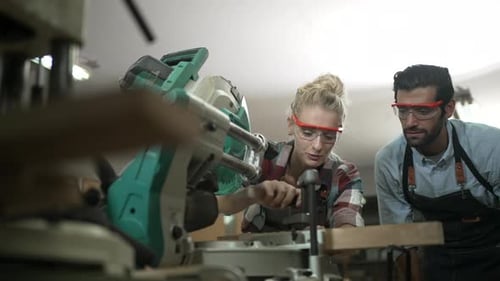 Carpenters are working together at workshop.