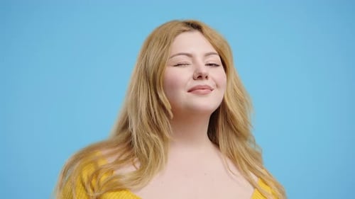 Blond Woman Smiling and Winking in Close Up