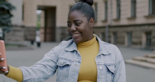 Young Woman Uses Cellphone to Video Call