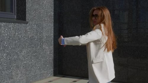 Stylish Woman Dancing Outdoors in Urban Environment