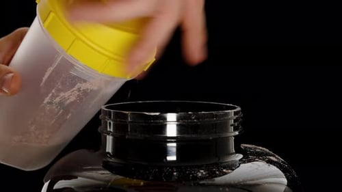 Pouring Protein Powder into a Tub Container