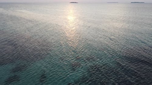 Beautiful aerial sunset view over sea surface beautiful wave. Amazing light sunset or sunrise sky ov
