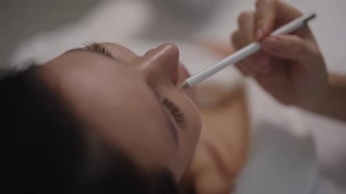 Woman Receiving Lip Treatment at a Beauty Salon