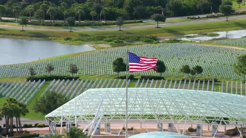 Aerial view of American flag at sprawling cemetery