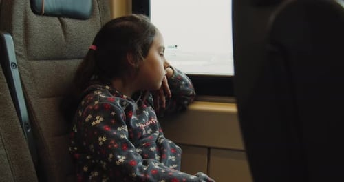 Sad Little Girl Looking Out the Train Window