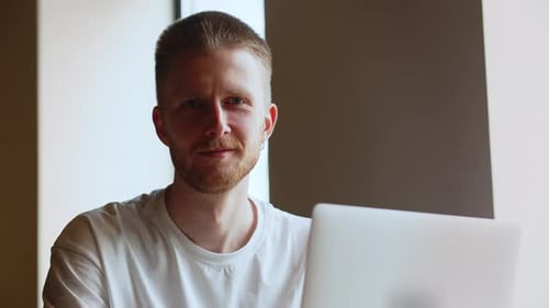 Man Working on Laptop in Home Office