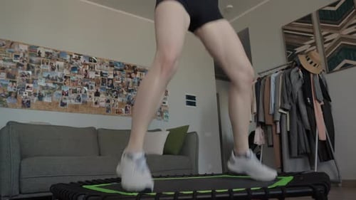 Woman Exercising on Small Trampoline at Home