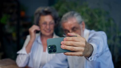 Senior Couple Taking Selfie with Phone Indoors
