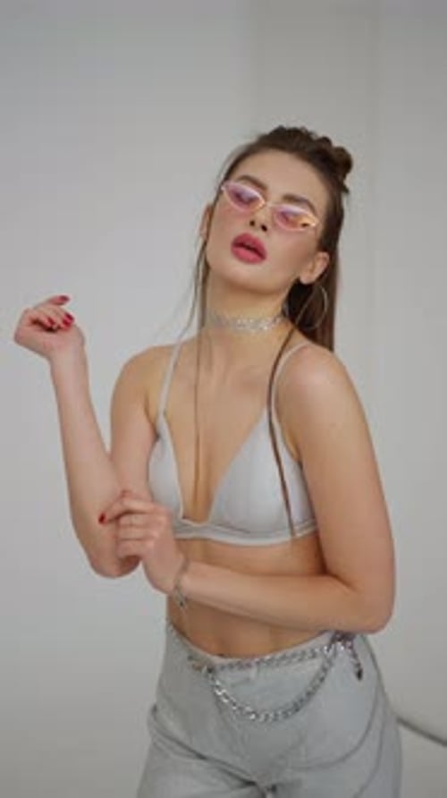 A Model Girl Demonstrates a Fashionable Outfit on the Catwalk