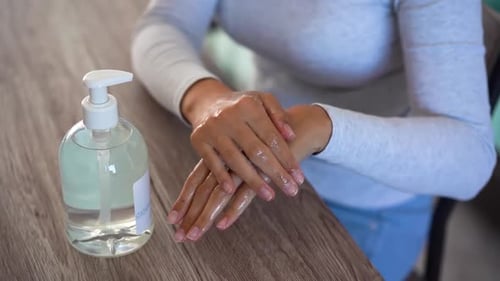 Woman Applies Hand Sanitizer for Hygiene Protection