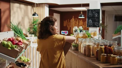 Woman in Bio Food Shop Helped By Vendor