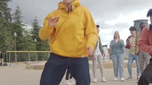 Energetic Dance Performance with Supportive Young Friends