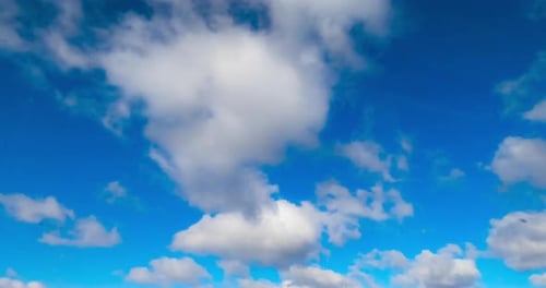 Fantastic azure sky with white clouds flying quickly by. Summer sky timelapse. Low angle view.