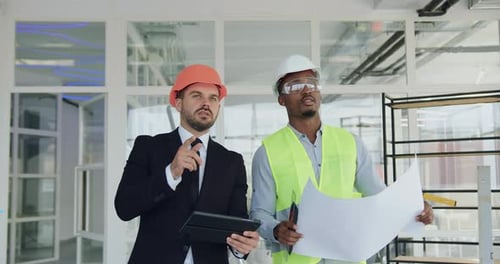 Portrait of man main manager with professional african american engineer in unfinished office