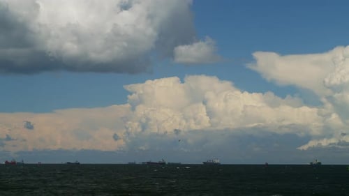 Timelapse Movement of Cumulus Rain Clouds Over the Sea with Ships