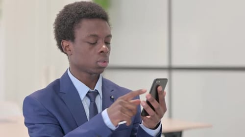 Young Adult Using Phone in Workplace