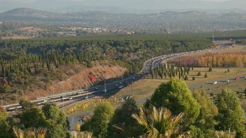 Canberra Highway Traffic Interweaves in Autumn Slow Motion