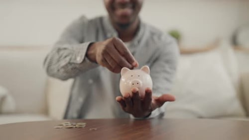 Happy African Man Saving Up Money for Dream Closeup of Hands with Piggy Bank Young Adult Black Male