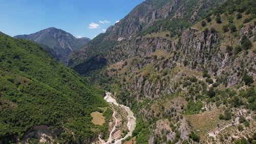Beautiful valley through rocky mountains, river streaming on peaceful landscape in Albania