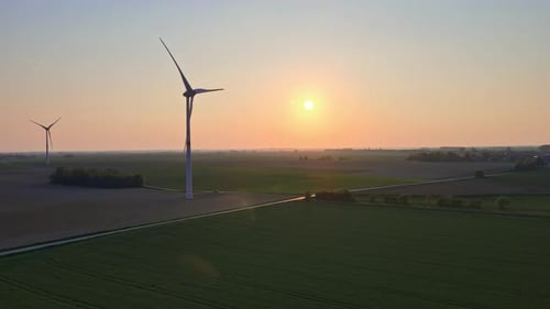 Wind Turbines In Field Against Sunset Sky - aerial drone shot