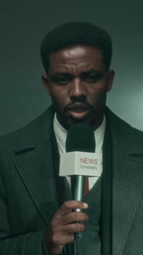 Vertical of Young Black Male Journalist Covering Crime Case for News Channel