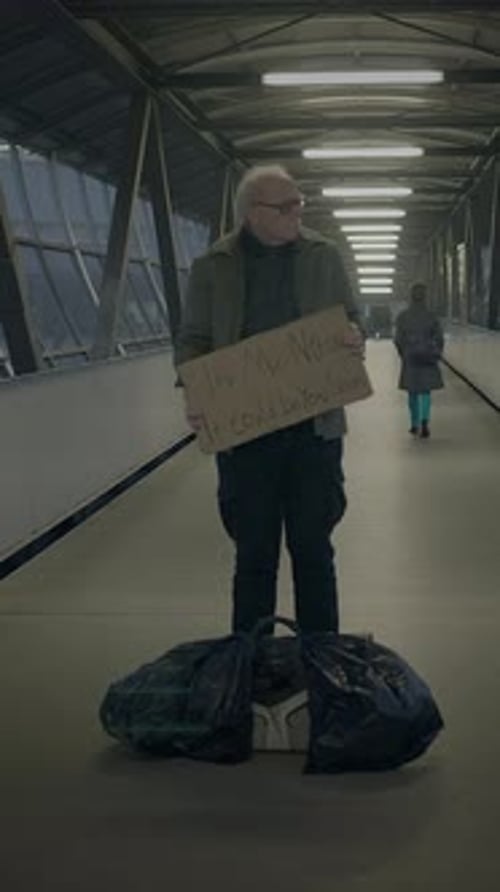 A Solitary Figure Stands in a Modern Corridor Holding a Cardboard Box in Their Hand