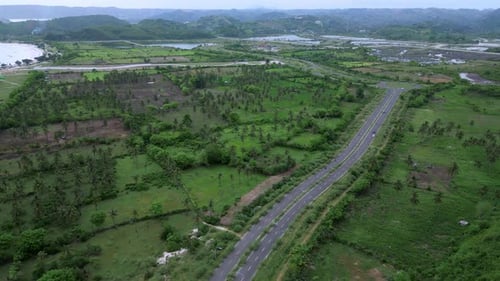 Highangle Shot Capturing Vehicle Movement On Vibrant Coast Road