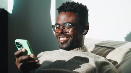 Happy Man Watching Video in Smartphone