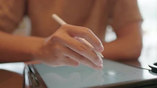Man's hand writing on tablet page sitting with coffee