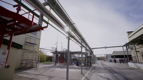 Motion Along Gas and Oil Refinery Plant Yard with Pipelines