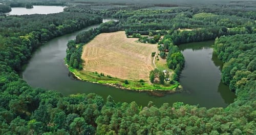 Curvy river and forests. Aerial view of wildlife in Poland.