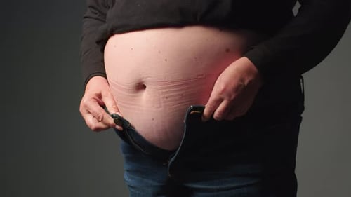 Woman with Belly Fat Getting Dressed Putting Pants on