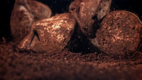 Chocolate Truffles Falling onto Cocoa Powder Surface