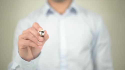 In Office Man Writing on Transparent Screen