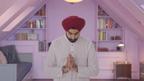 Man Praying Indoors Wearing Turban