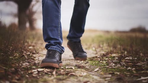 Man Walks on Wooded Area on Hike for Walk in Autumn Outdoors Nature Landscape
