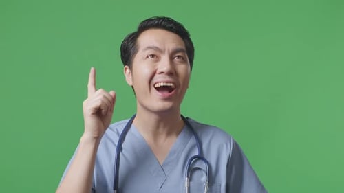 Close Up Of Male Doctor With Stethoscope Thinking Then Raising His Index Finger On Green Screen