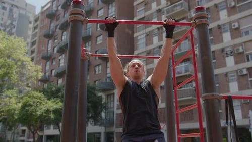 Man Doing Hanging Leg Raises during Outdoor Workout