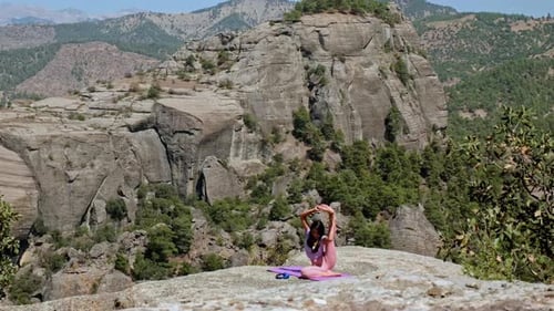 Woman Practicing Yoga Stretch in Nature with Mountain View Outdoors