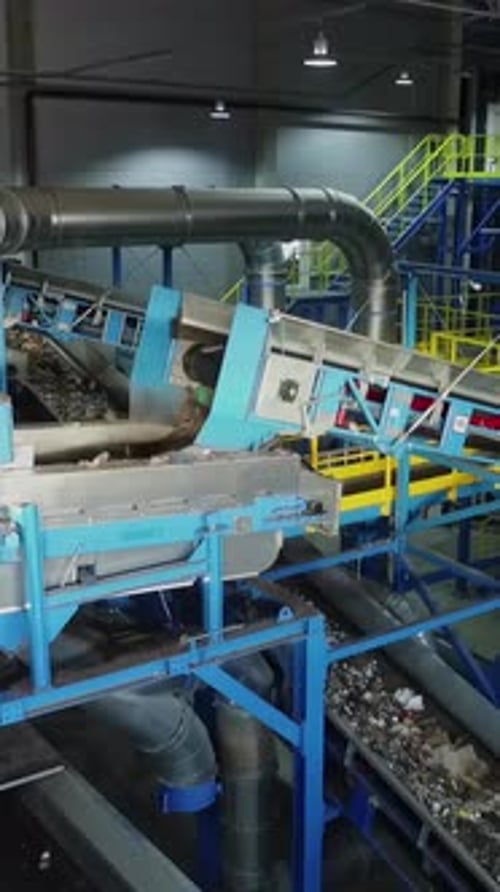 Vertical Flythrough of Trash Sorting Facility with Conveyor Belts Dropping Waste