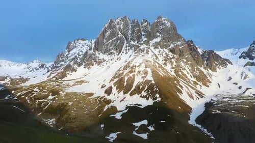 Cinematic drone shot of the snow-covered Georgian Dolomites in the Caucasus mountains in Georgia